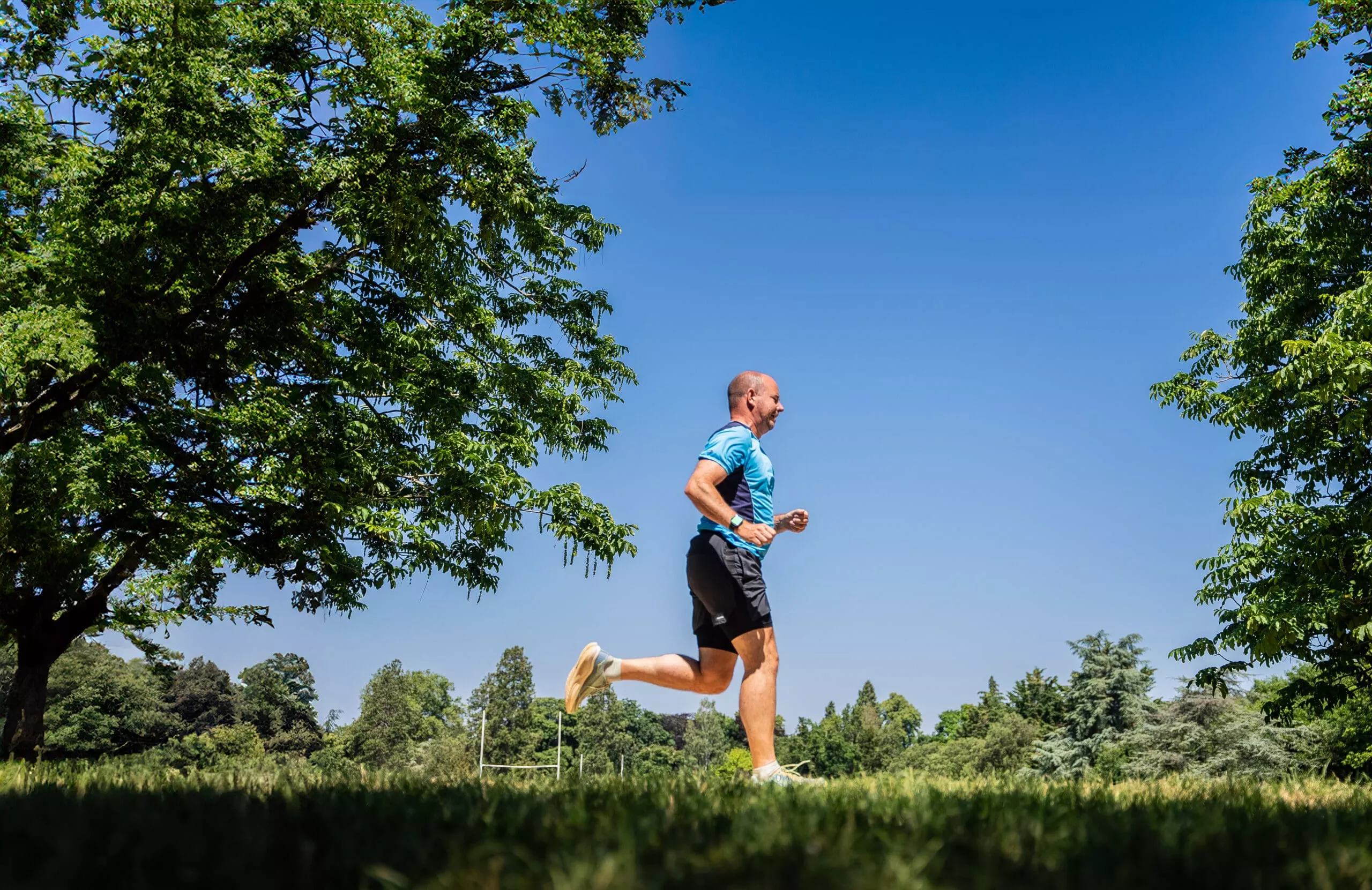 man running in a park on a sunny day
